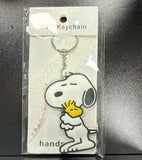 PVC Keychain - Peanuts - Snoopy Hugging Woodstock - foto real del paquete
