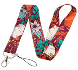 Lanyard - Floral Pattern with White, Teal, and Orange Flowers on a Burgundy Background