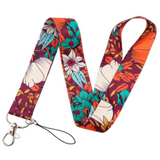 Lanyard - Floral Pattern with White, Teal, and Orange Flowers on a Burgundy Background