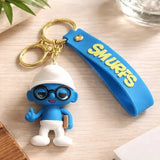 3D PVC Figure Keychain - Los Pitufos Pitufo Filósofo - Brainy Smurf Book Thumbs Up