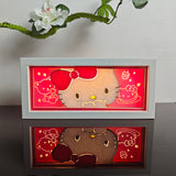 Hello Kitty peeking with red bow anime light box — lit, front view