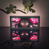 Demon Slayer Nezuko Kamado awakened demon form anime light box — dark room atmospheric