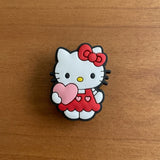 Crocs Charm - Hello Kitty - In Red Overalls Holding Heart